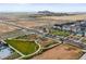 Aerial view of new homes, play area, picnic pavilion, and expansive undeveloped land at 21440 E 61St Dr, Aurora, CO 80019