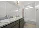 Bathroom featuring double sinks, granite counters, and a shower-tub combo at 21440 E 61St Dr, Aurora, CO 80019
