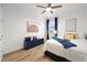 Bright bedroom featuring a ceiling fan, wood floors, and stylish blue accents at 21440 E 61St Dr, Aurora, CO 80019