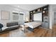 Cozy bedroom with a pull-down bed and stylish built-in shelving at 21440 E 61St Dr, Aurora, CO 80019