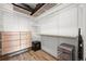 Walk-in closet with custom shelving and hardwood floors at 21440 E 61St Dr, Aurora, CO 80019