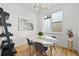 Bright dining room featuring a modern light fixture and stylish decor, creating an inviting space at 21440 E 61St Dr, Aurora, CO 80019