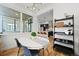 Well-lit dining room with modern chandelier, table setting, and a view into the stylish kitchen at 21440 E 61St Dr, Aurora, CO 80019