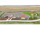 Aerial view of a fenced dog park featuring play structures and shade canopies, perfect for pet owners at 21440 E 61St Dr, Aurora, CO 80019
