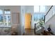 Bright entryway featuring a vibrant yellow door and an abundance of natural light from large windows at 21440 E 61St Dr, Aurora, CO 80019