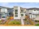 Modern two-story home features fenced yard, balcony, and stylish architectural details at 21440 E 61St Dr, Aurora, CO 80019