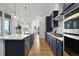 Contemporary kitchen featuring stainless steel appliances, white countertops, and an open design concept at 21440 E 61St Dr, Aurora, CO 80019