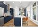 Bright kitchen features large island with seating, navy cabinets, stainless steel appliances at 21440 E 61St Dr, Aurora, CO 80019