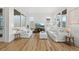Airy living room with large windows, comfortable white couches, and warm hardwood floors, perfect for relaxing at 21440 E 61St Dr, Aurora, CO 80019