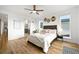 Bright main bedroom with hardwood floors and decorative wall hangings at 21440 E 61St Dr, Aurora, CO 80019