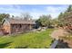 Spacious backyard with manicured lawn, patio seating, and mature trees at 10801 W 29Th Ave, Lakewood, CO 80215