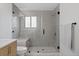 Bathroom features a glass-enclosed shower, gray tiling, and a built-in bench for a spa-like experience at 10801 W 29Th Ave, Lakewood, CO 80215