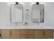 Bathroom features double sinks, wood cabinetry and sleek mirrors for a modern and functional design at 10801 W 29Th Ave, Lakewood, CO 80215