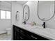 Stylish bathroom features double sinks, marble countertop and eye-catching mirrors for a luxurious feel at 10801 W 29Th Ave, Lakewood, CO 80215