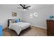 Charming bedroom features a ceiling fan, a large window, and neutral decor for a tranquil retreat at 10801 W 29Th Ave, Lakewood, CO 80215