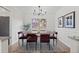 Well-lit dining room features a wooden table, modern chairs, and stylish wall art at 10801 W 29Th Ave, Lakewood, CO 80215
