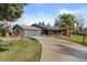 A charming house featuring a well-maintained lawn, mature trees and a long concrete driveway at 10801 W 29Th Ave, Lakewood, CO 80215