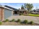 Home's front exterior shows brick finishes, a long driveway, and tidy landscaping at 10801 W 29Th Ave, Lakewood, CO 80215
