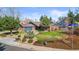 Charming brick home featuring a two car garage, mature trees, and a lush front yard at 10801 W 29Th Ave, Lakewood, CO 80215