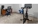 Bright room featuring an exercise bike, dumbbells, computer desk and chair at 10801 W 29Th Ave, Lakewood, CO 80215