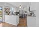 Bright modern kitchen with white cabinets, stainless steel appliances, and hardwood floors at 10801 W 29Th Ave, Lakewood, CO 80215