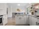 Eat-in kitchen with granite countertops, light wood floors, an island, and plenty of natural light at 10801 W 29Th Ave, Lakewood, CO 80215