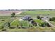 Aerial view of the property showcasing a fenced backyard, stone patio with pergola, and mature trees at 6051 E 160Th Pl, Brighton, CO 80602