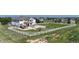 Large fenced backyard featuring white fencing, spacious lawn, and a stone patio with a pergola at 6051 E 160Th Pl, Brighton, CO 80602