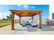 Outdoor gazebo seating area with string lights and cushioned seating at 6051 E 160Th Pl, Brighton, CO 80602