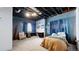 Basement bedroom featuring a desk and bed with blue accent wall at 6051 E 160Th Pl, Brighton, CO 80602