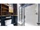 Bathroom with a glass-enclosed shower and modern black and white accents at 6051 E 160Th Pl, Brighton, CO 80602