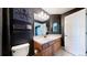 Bathroom featuring a vanity with a sink and decorative mirror and octopus wall decor at 6051 E 160Th Pl, Brighton, CO 80602