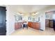 Bathroom featuring dual sinks, wood cabinets, tile floors, and modern lighting at 6051 E 160Th Pl, Brighton, CO 80602