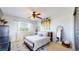 Bright bedroom with a ceiling fan, window with views, and decorative accents at 6051 E 160Th Pl, Brighton, CO 80602