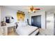 Well-lit bedroom with a ceiling fan, desk and shelving accents, and large closet at 6051 E 160Th Pl, Brighton, CO 80602
