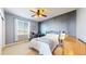 Cozy bedroom features a ceiling fan, a dark accent wall, and plenty of natural light at 6051 E 160Th Pl, Brighton, CO 80602