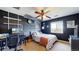 Bedroom featuring a ceiling fan, unique wall art, and a work station for remote work at 6051 E 160Th Pl, Brighton, CO 80602
