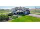 Exterior elevation of home featuring a well manicured front yard and three car garage at 6051 E 160Th Pl, Brighton, CO 80602