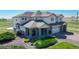 Charming two-story home featuring a three-car garage and a cozy front porch at 6051 E 160Th Pl, Brighton, CO 80602