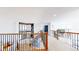 Bright hallway with wood and iron railing, and an artistic display of wood and glass at 6051 E 160Th Pl, Brighton, CO 80602