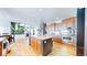 Gourmet kitchen features an island with seating, stainless appliances, and plenty of cabinet space at 6051 E 160Th Pl, Brighton, CO 80602