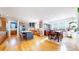 Open-concept kitchen with stainless appliances, island with seating, and dining area at 6051 E 160Th Pl, Brighton, CO 80602
