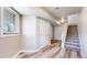 Finished basement with wood-look floors, a window, and a staircase to the upper level at 2503 N Ogden St, Denver, CO 80205