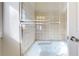 Close up of shower over tub with glass doors and tiled walls, illuminated with lights inside at 2503 N Ogden St, Denver, CO 80205