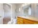 Bright bathroom featuring a single sink vanity, medicine cabinet and a shower over tub with tiled walls at 2503 N Ogden St, Denver, CO 80205