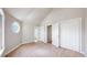 Bedroom features carpeted floor, vaulted ceiling, three doorways, and unique window at 2503 N Ogden St, Denver, CO 80205