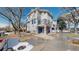 Exterior view of townhome featuring a blue garage door, stone accents and upper level balcony at 2503 N Ogden St, Denver, CO 80205