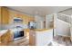 Efficient kitchen featuring stainless steel appliances, wooden cabinetry, and modern fixtures at 2503 N Ogden St, Denver, CO 80205