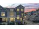 Exterior front view of townhomes, showcasing architectural details, landscaping, and neighborhood street at 1530 Terry St, Longmont, CO 80501