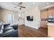 Inviting living area with sleek hardwood floors, a ceiling fan, and modern finishes in an open-concept design at 1530 Terry St, Longmont, CO 80501
